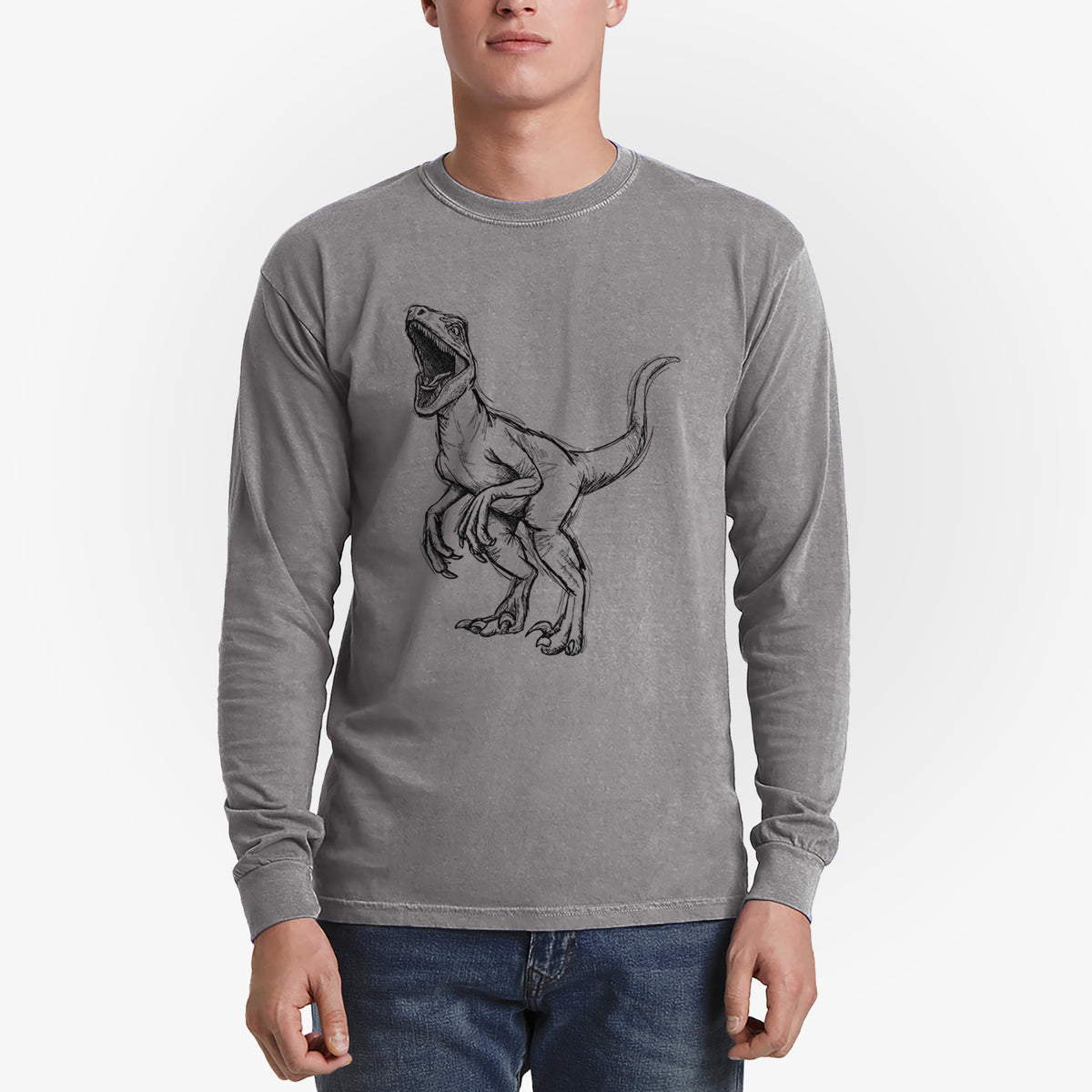Man wearing a grey Comfort Colors long sleeve shirt printed with a black ink illustration of a Velociraptor roaring.