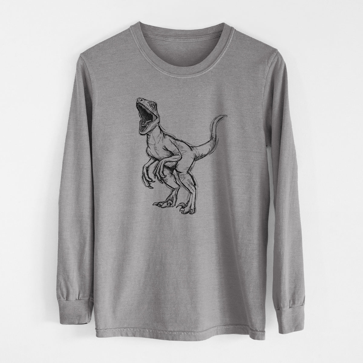 Grey Comfort Colors long sleeve shirt laid flat, printed with a black ink illustration of a Velociraptor roaring.