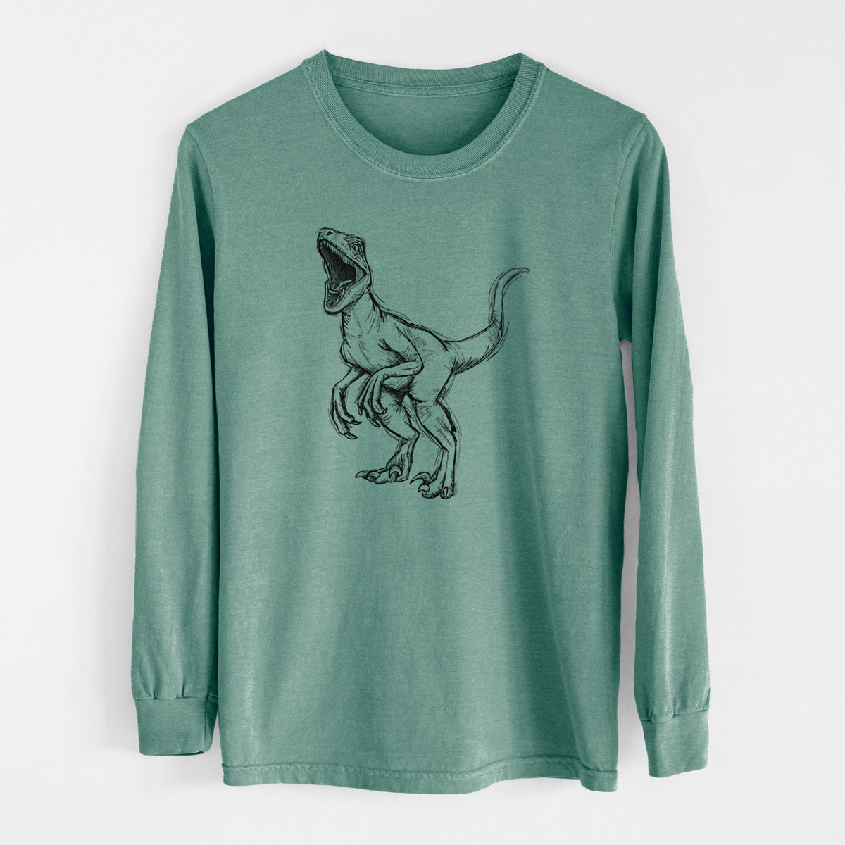 Pine green Comfort Colors long sleeve shirt laid flat, printed with a black ink illustration of a Velociraptor roaring.