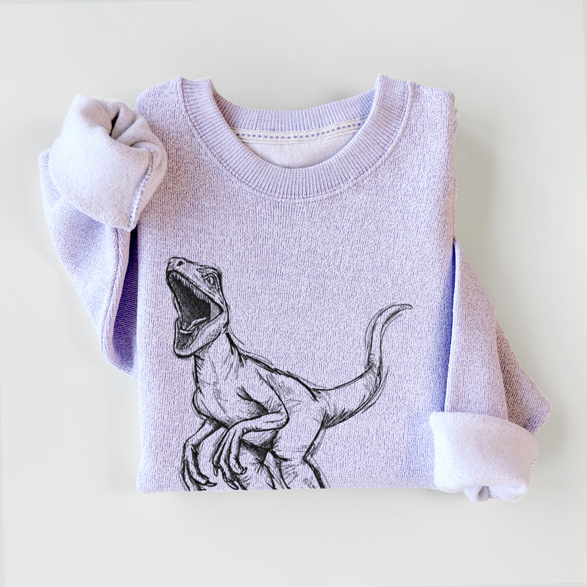 Ice purple knit sweatshirt printed with a black ink illustration of a Velociraptor roaring, styled flat.