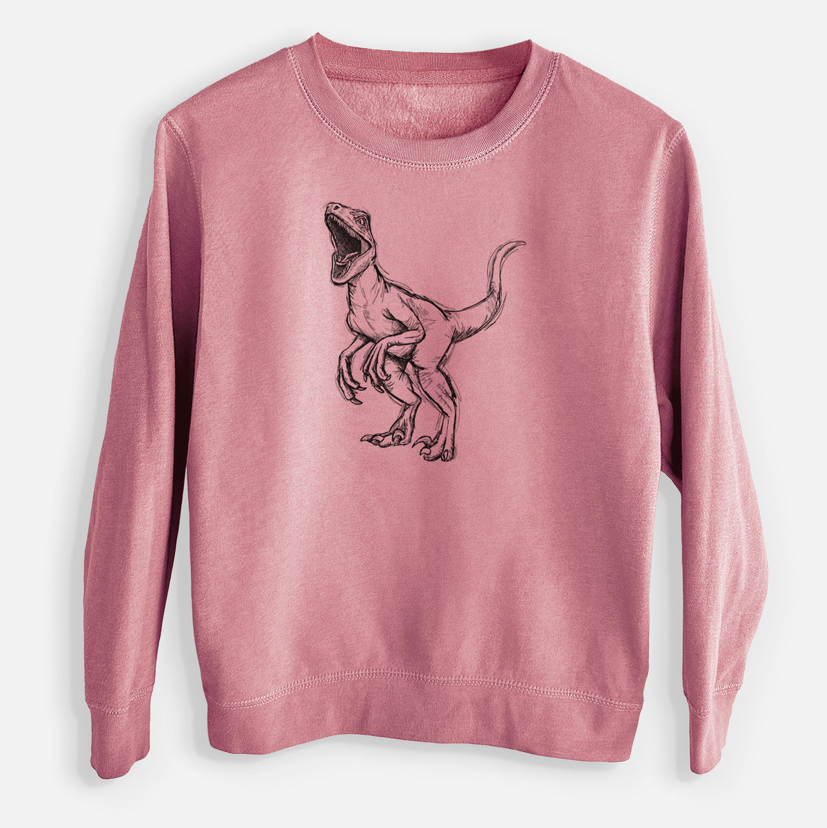 Mauve pink youth crewneck sweatshirt laid flat, printed with a black ink illustration of a Velociraptor roaring.