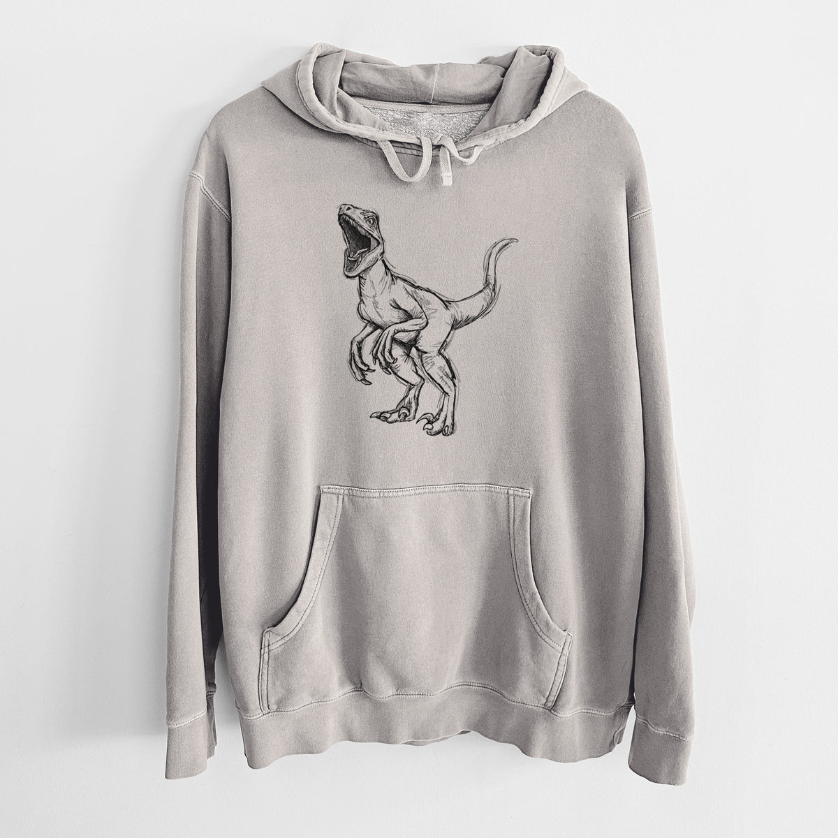 Cement grey pigment dyed hoodie laid flat, printed with a black ink illustration of a Velociraptor roaring.