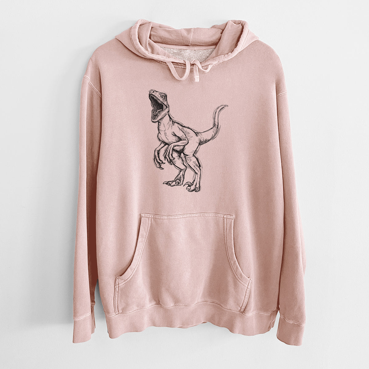 Dusty pink pigment dyed hoodie laid flat, printed with a black ink illustration of a Velociraptor roaring.