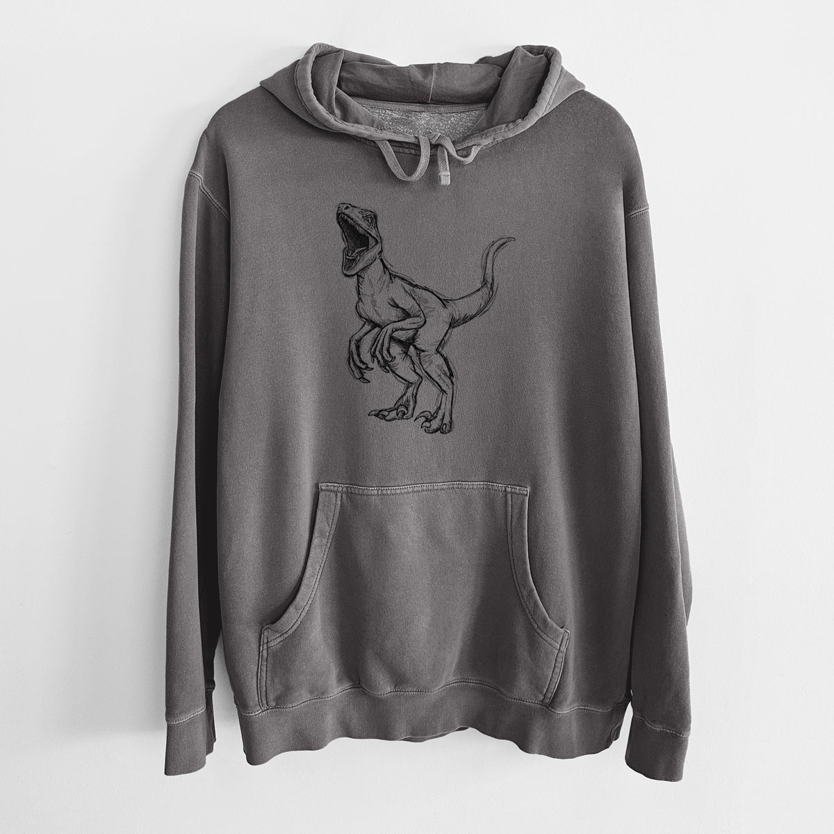 Faded black pigment dyed hoodie laid flat, printed with a black ink illustration of a Velociraptor roaring.