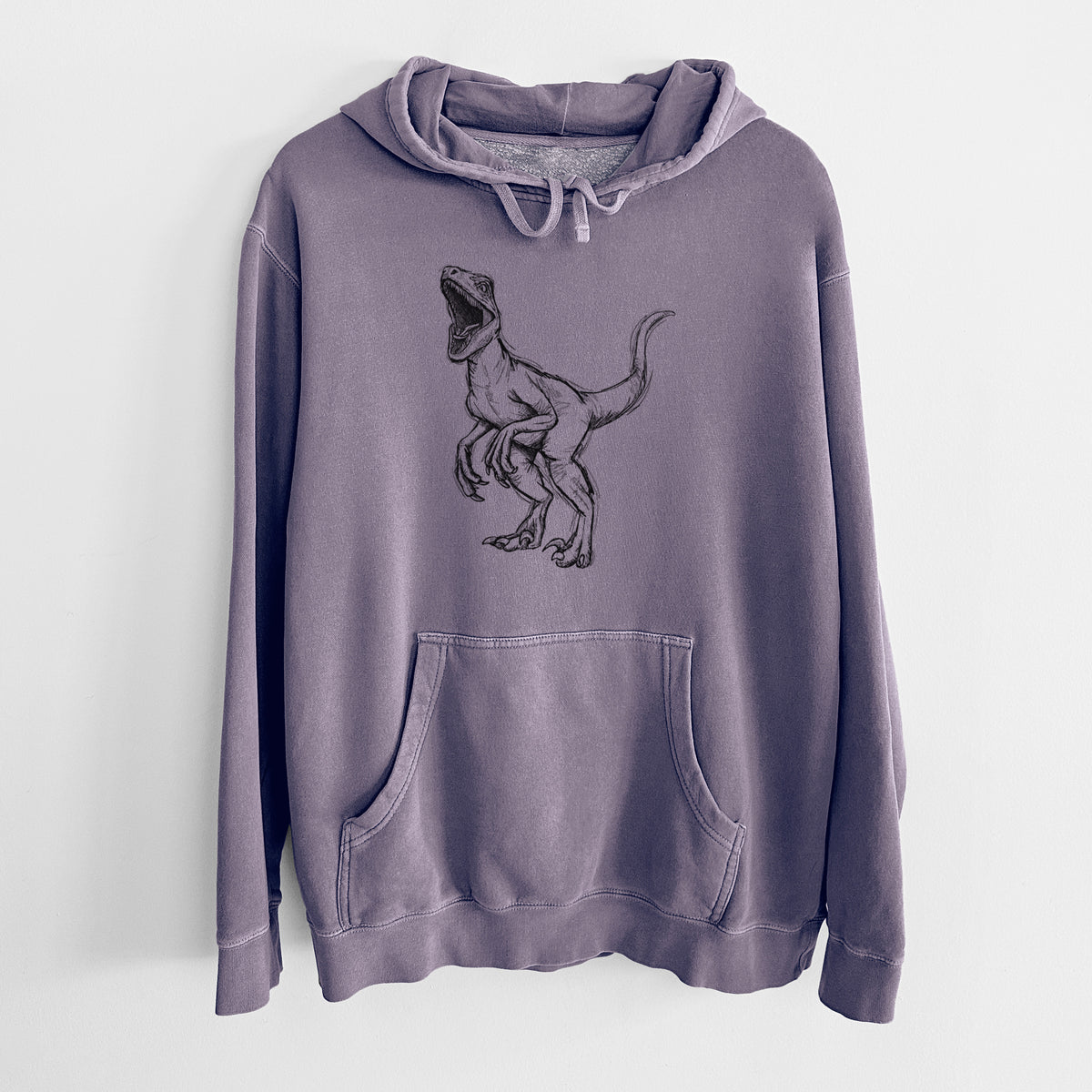 Plum purple pigment dyed hoodie laid flat, printed with a black ink illustration of a Velociraptor roaring.