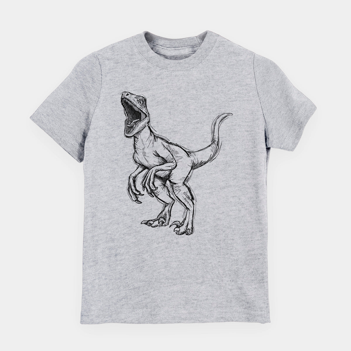 Heather grey youth t-shirt laid flat, printed with a black ink illustration of a Velociraptor roaring.