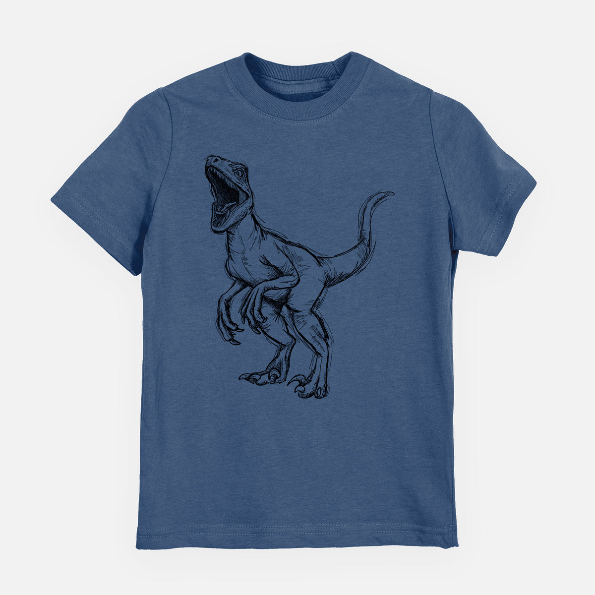 Indigo blue youth t-shirt laid flat, printed with a black ink illustration of a Velociraptor roaring.