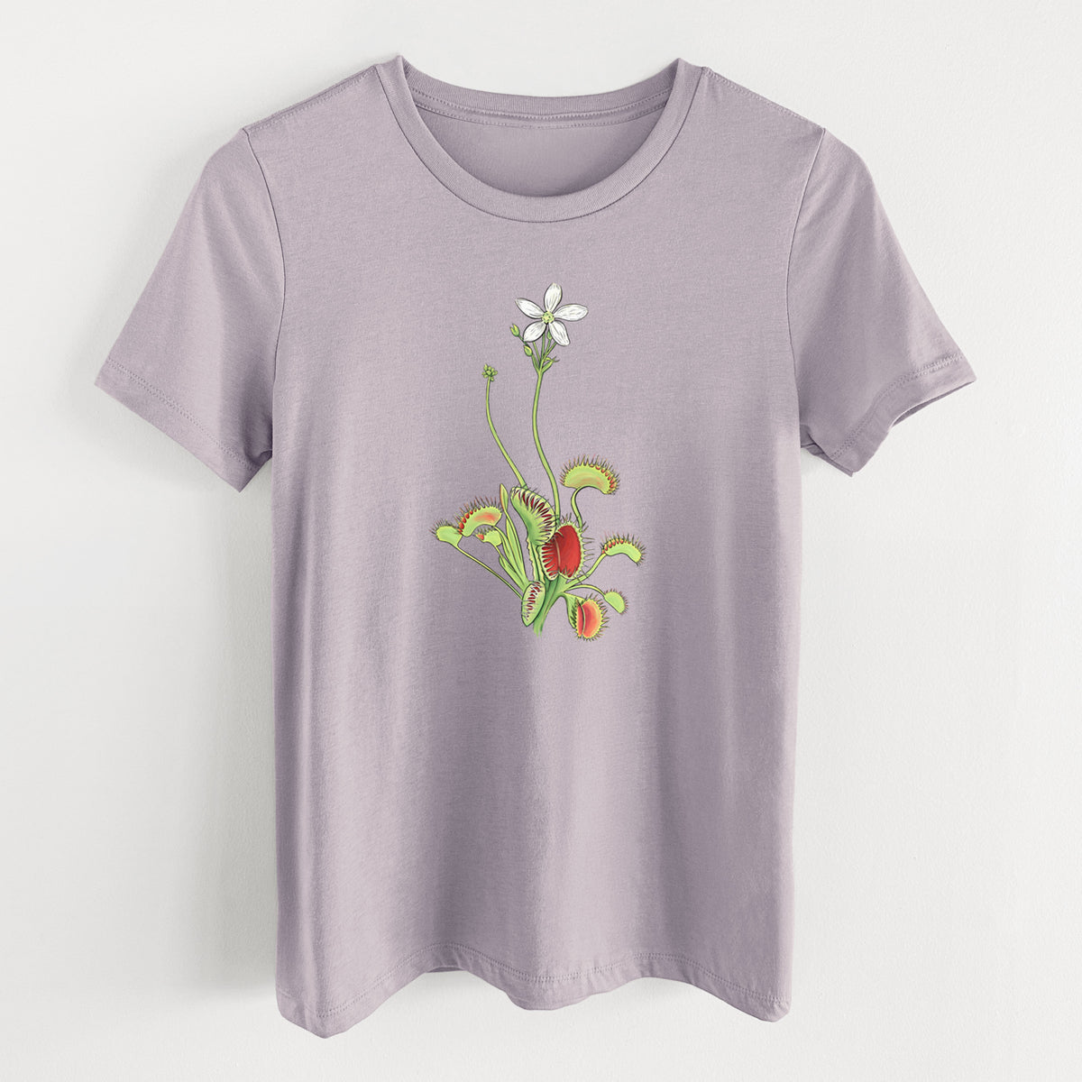 Light violet women's relaxed fit cotton t-shirt laid flat, printed with a full-color illustration of a Venus flytrap plant with red traps and a small white flower.