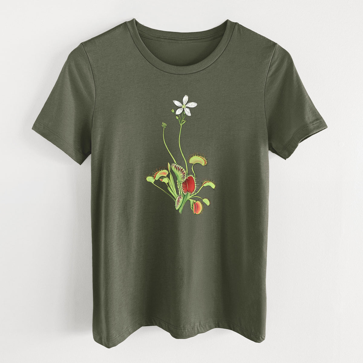 Military green women's relaxed fit cotton t-shirt laid flat, printed with a full-color illustration of a Venus flytrap plant with red traps and a small white flower.