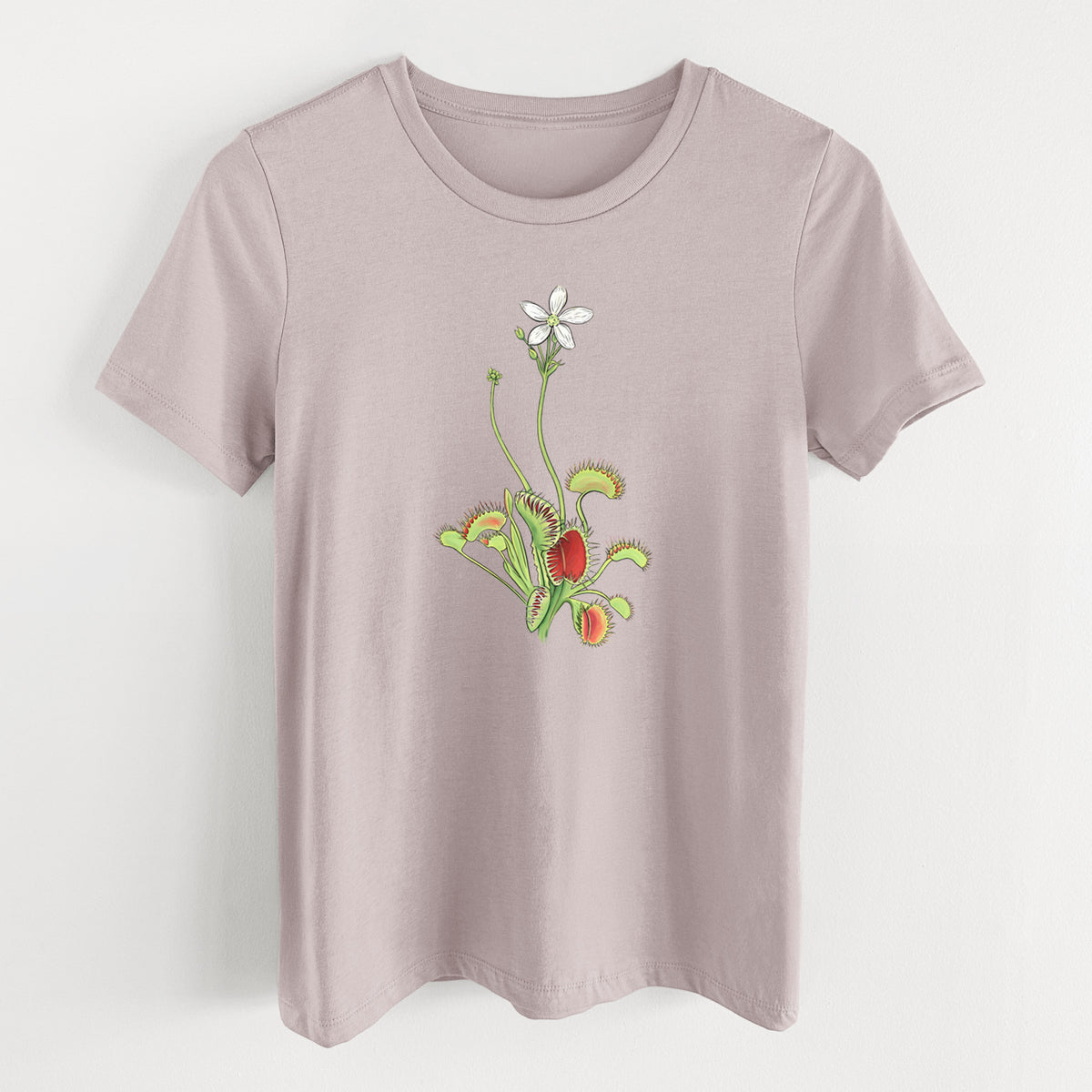 Pink gravel women's relaxed fit cotton t-shirt laid flat, printed with a full-color illustration of a Venus flytrap plant with red traps and a small white flower.