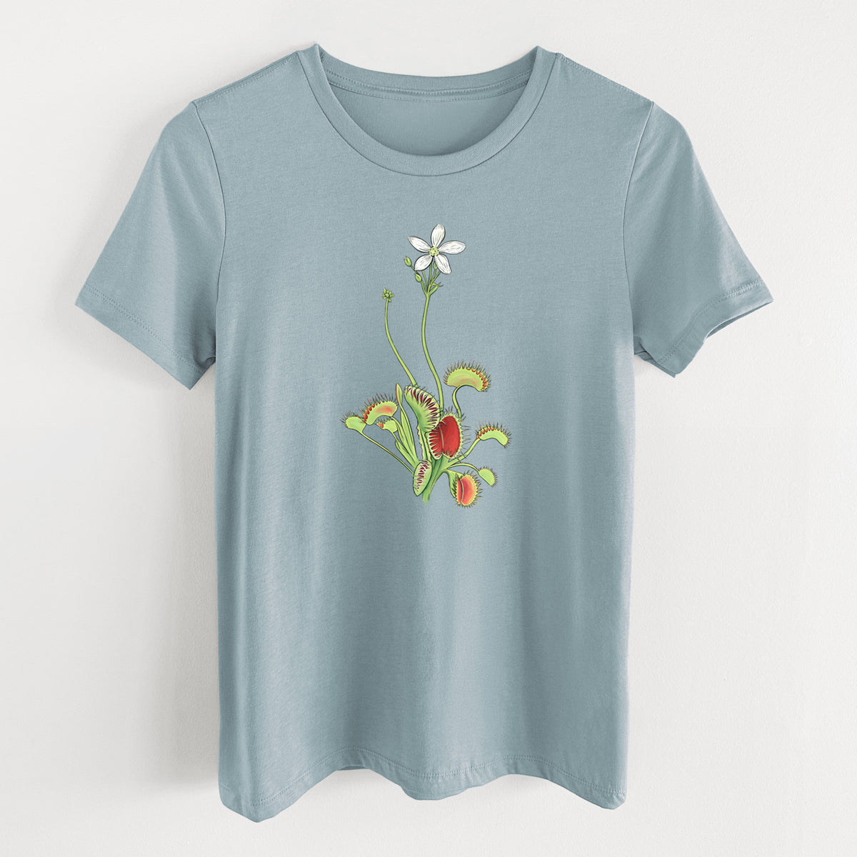 Vintage denim women's relaxed fit cotton t-shirt laid flat, printed with a full-color illustration of a Venus flytrap plant with red traps and a small white flower.