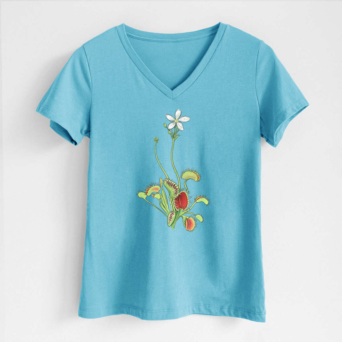 Turquoise women's relaxed fit cotton V-neck t-shirt laid flat, printed with a full-color illustration of a Venus flytrap plant with red traps and a small white flower.