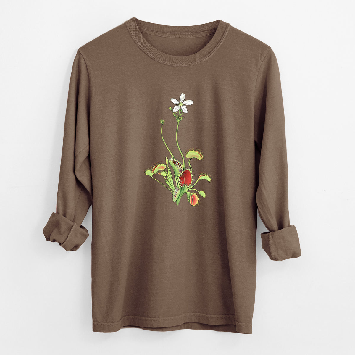 Espresso brown Comfort Colors long sleeve shirt laid flat with the cuffs rolled, printed with a full-color illustration of a Venus flytrap plant with red traps and a small white flower.