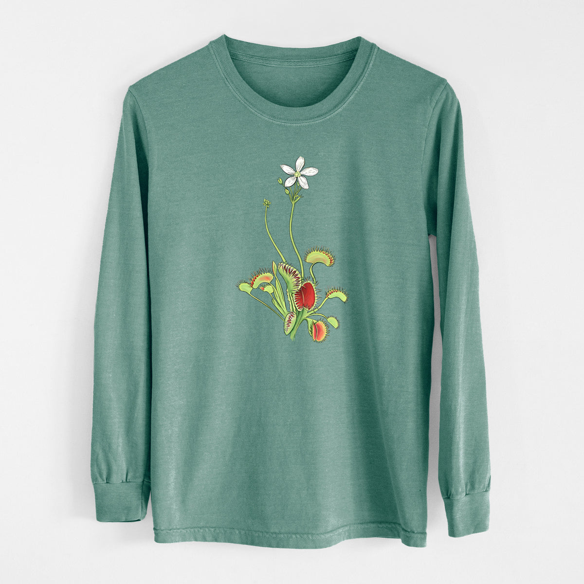 Pine green Comfort Colors long sleeve shirt laid flat, printed with a full-color illustration of a Venus flytrap plant with red traps and a small white flower.