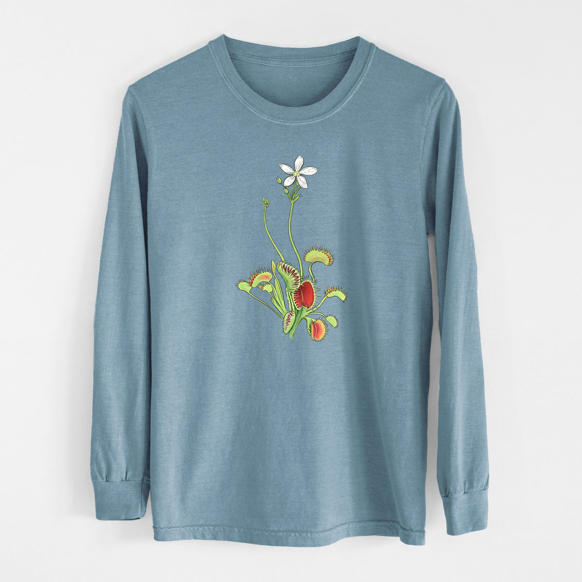 Steel blue Comfort Colors long sleeve shirt laid flat, printed with a full-color illustration of a Venus flytrap plant with red traps and a small white flower.