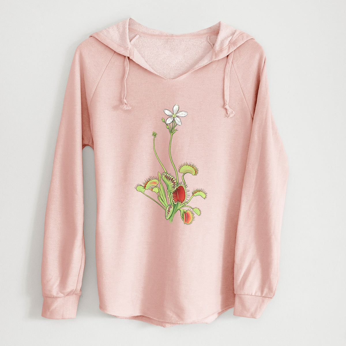 Blush pink women's Cali Wave hooded sweatshirt laid flat, printed with a full-color illustration of a Venus flytrap plant with red traps and a small white flower.