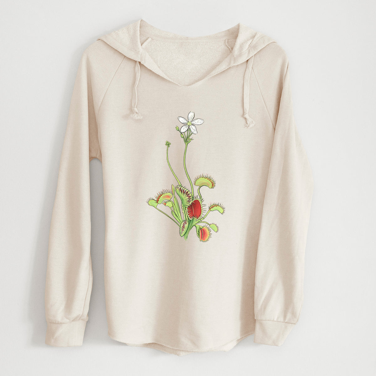 Bone cream women's Cali Wave hooded sweatshirt laid flat, printed with a full-color illustration of a Venus flytrap plant with red traps and a small white flower.
