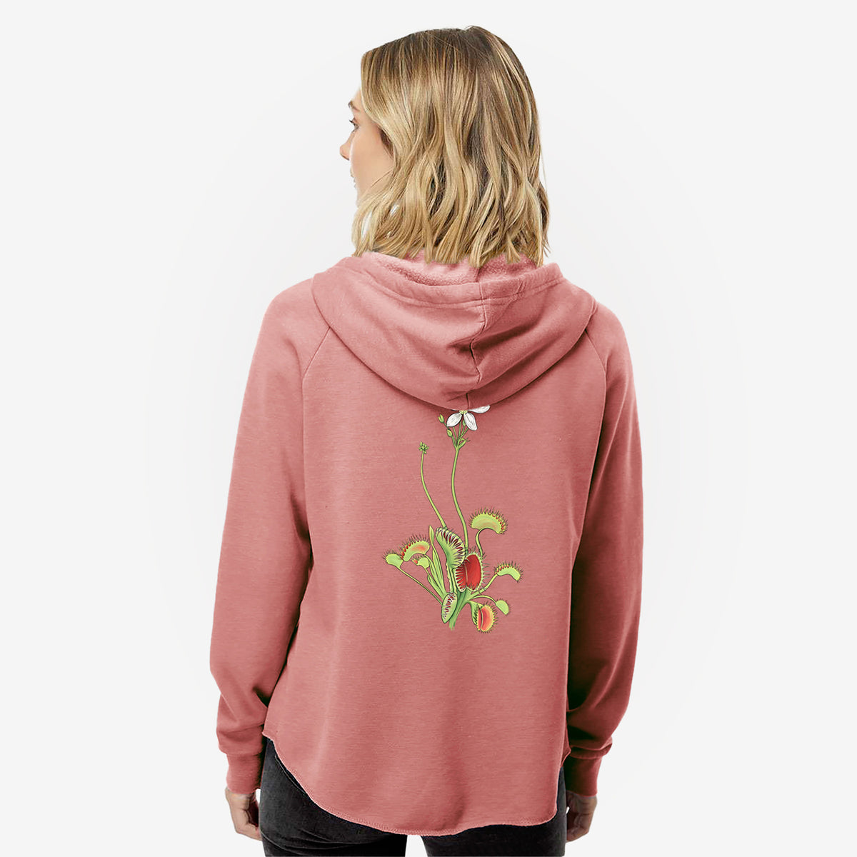 Woman wearing a dusty rose women's Cali Wave zip-up sweatshirt printed with a full-color illustration of a Venus flytrap plant with red traps and a small white flower, seen from behind.