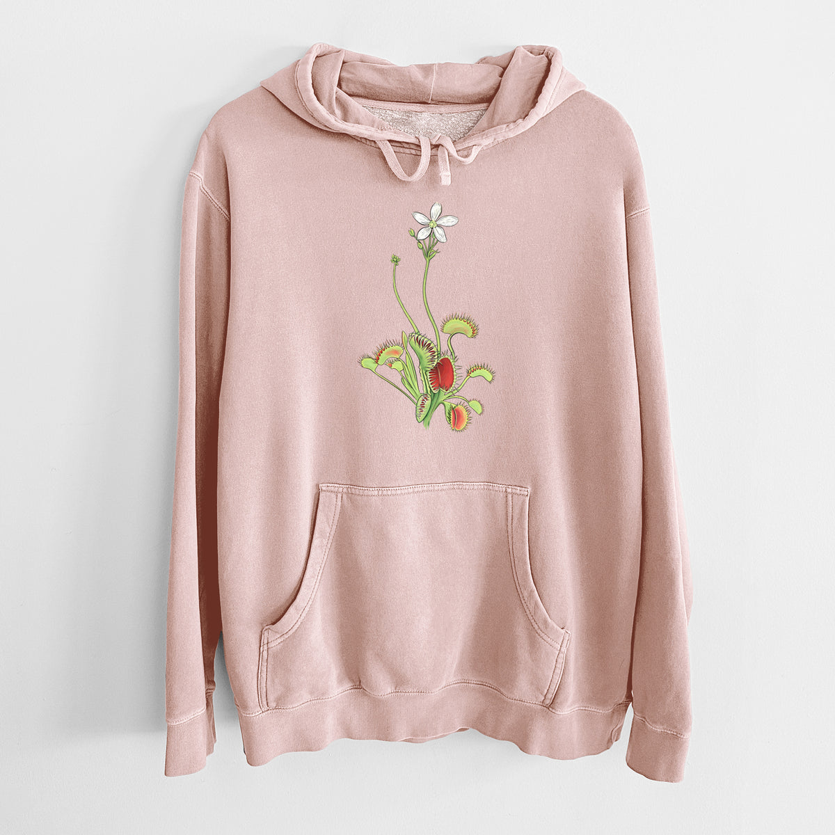 Dusty pink pigment dyed hoodie laid flat, printed with a full-color illustration of a Venus flytrap plant with red traps and a small white flower.
