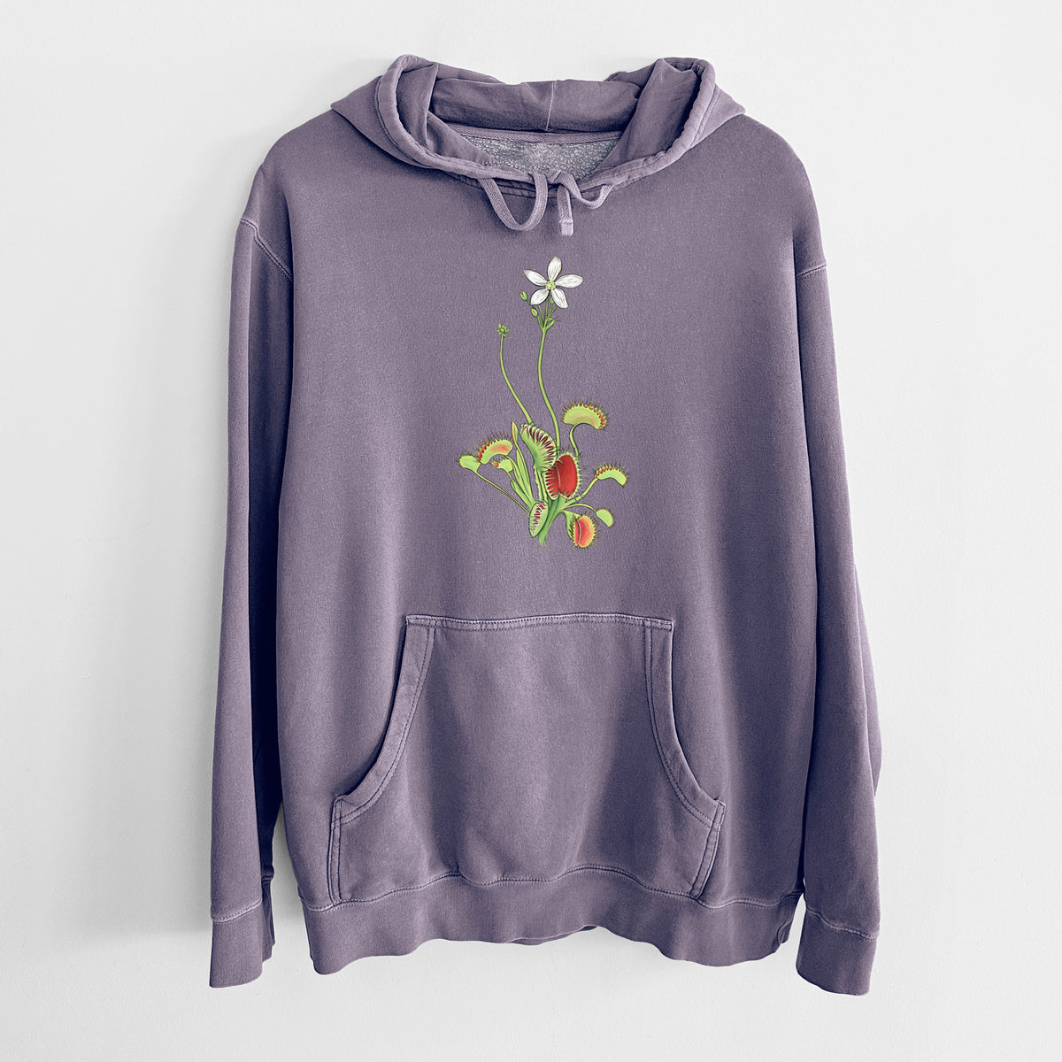 Plum purple pigment dyed hoodie laid flat, printed with a full-color illustration of a Venus flytrap plant with red traps and a small white flower.