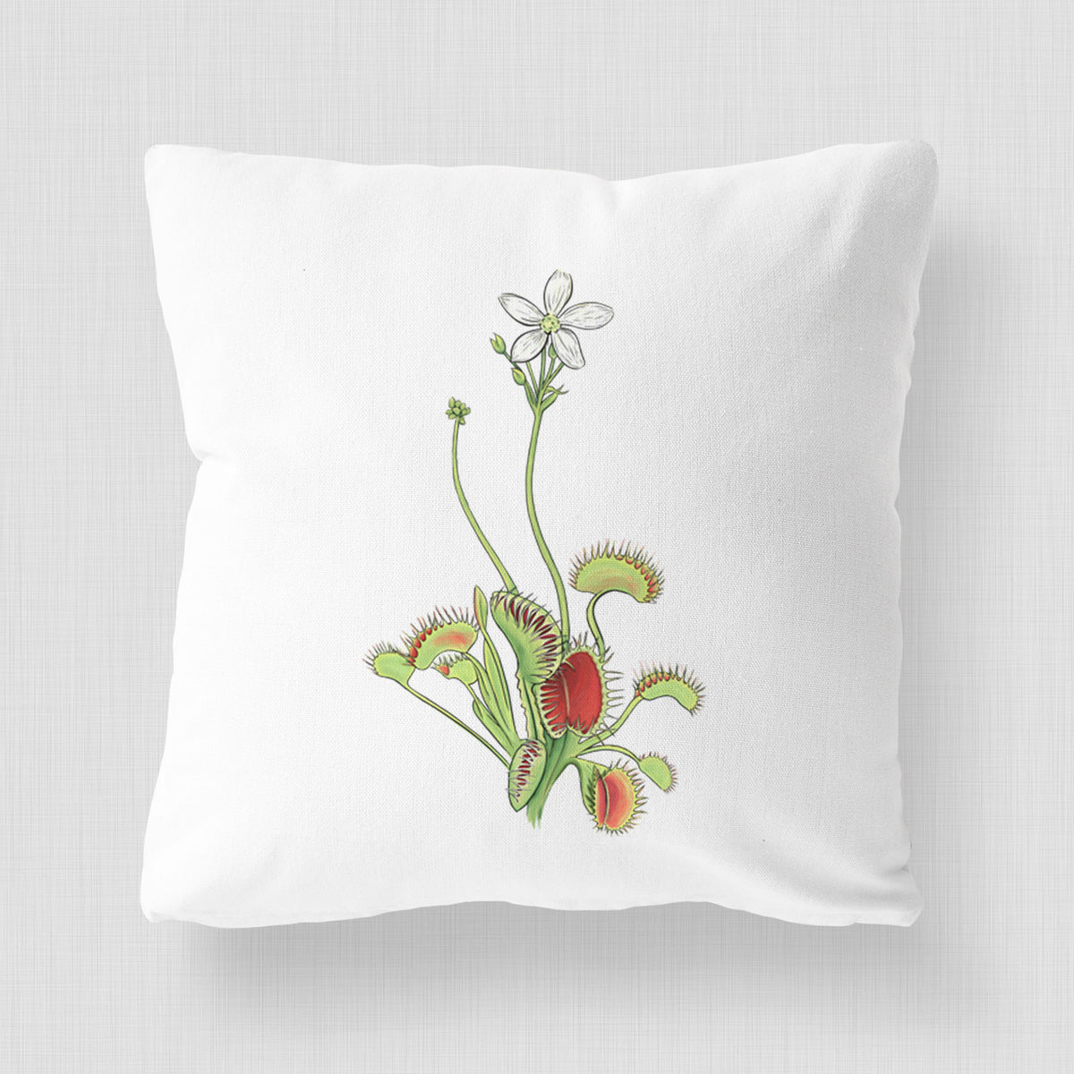 White pillow cover printed with a full-color illustration of a Venus flytrap plant with red traps and a small white flower.