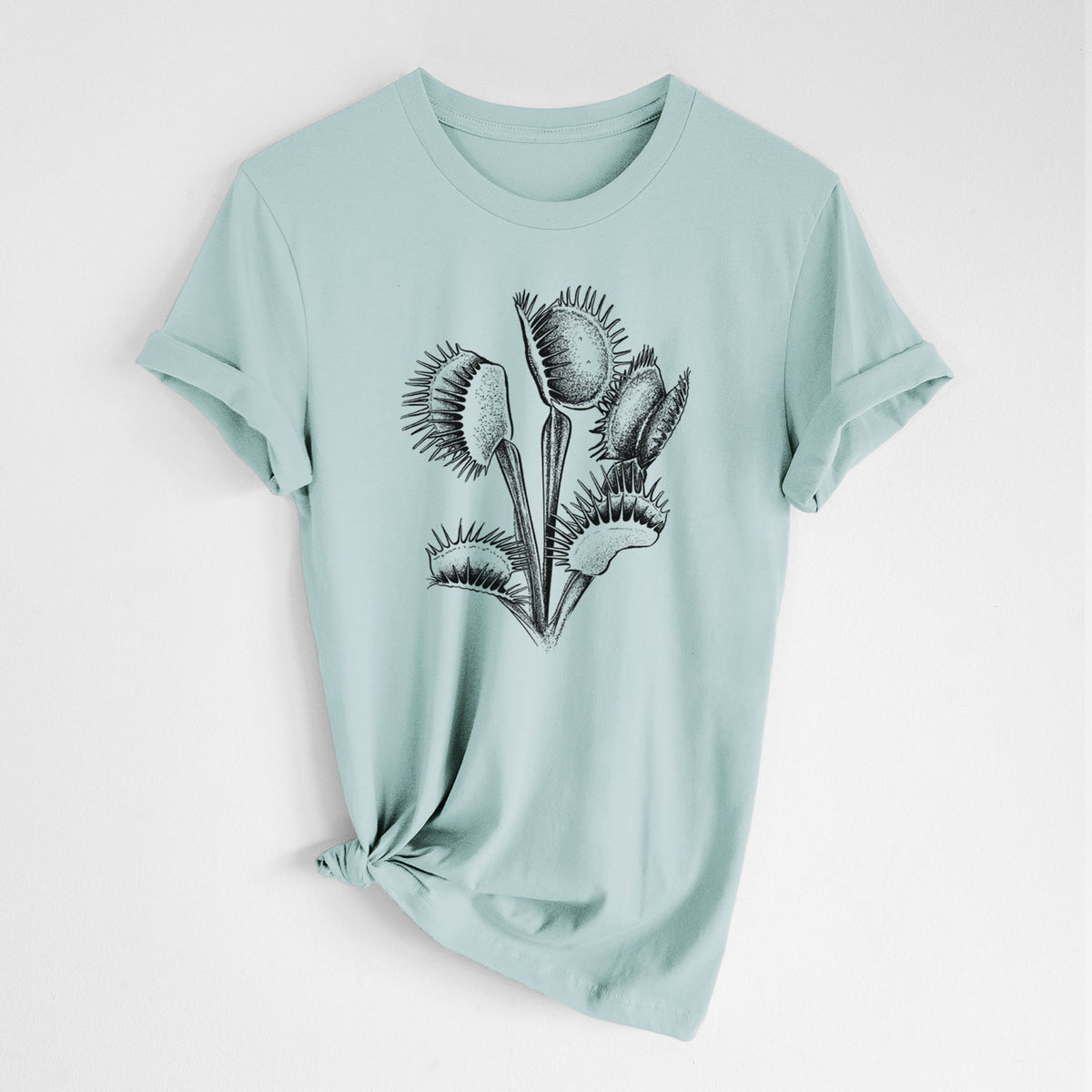 Dusty blue lightweight cotton t-shirt laid flat with the sleeves rolled, printed with a black ink illustration of a Venus flytrap plant with open traps.
