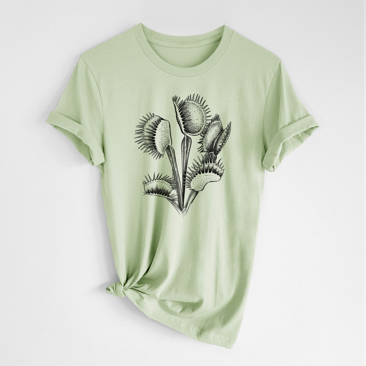Spring green lightweight cotton t-shirt laid flat with the sleeves rolled, printed with a black ink illustration of a Venus flytrap plant with open traps.