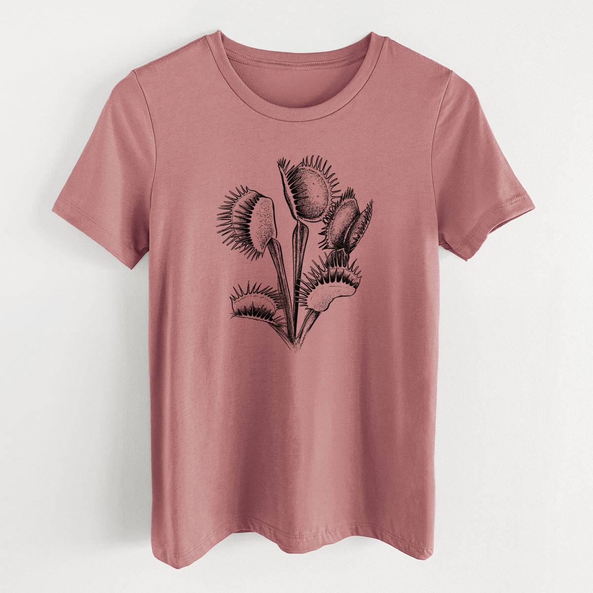 Mauve pink women's relaxed fit cotton t-shirt laid flat, printed with a black ink illustration of a Venus flytrap plant with open traps.