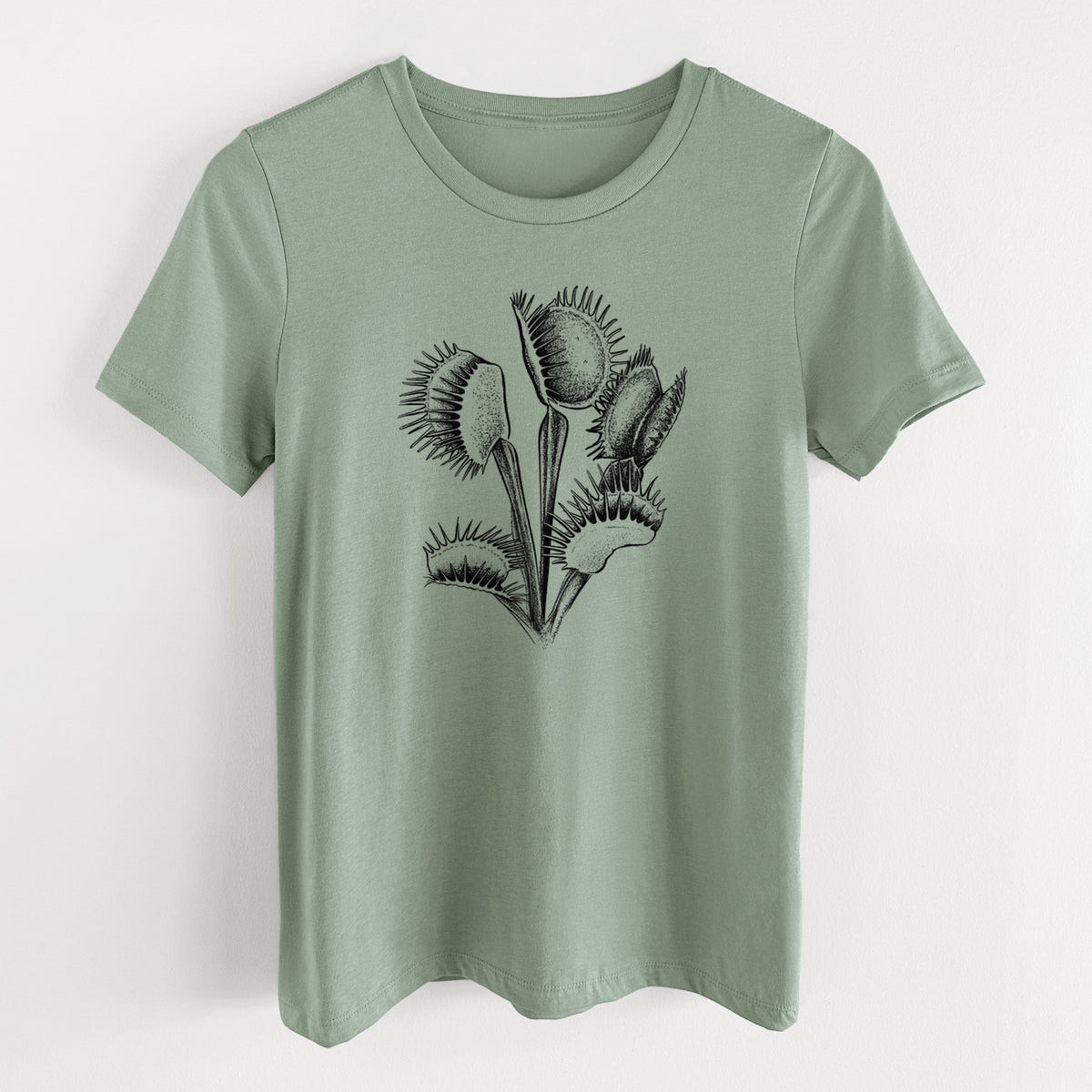 Sage green women's relaxed fit cotton t-shirt laid flat, printed with a black ink illustration of a Venus flytrap plant with open traps.