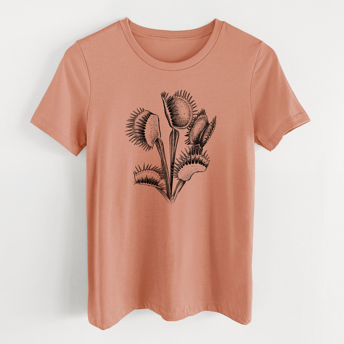 Terracotta orange women's relaxed fit cotton t-shirt laid flat, printed with a black ink illustration of a Venus flytrap plant with open traps.