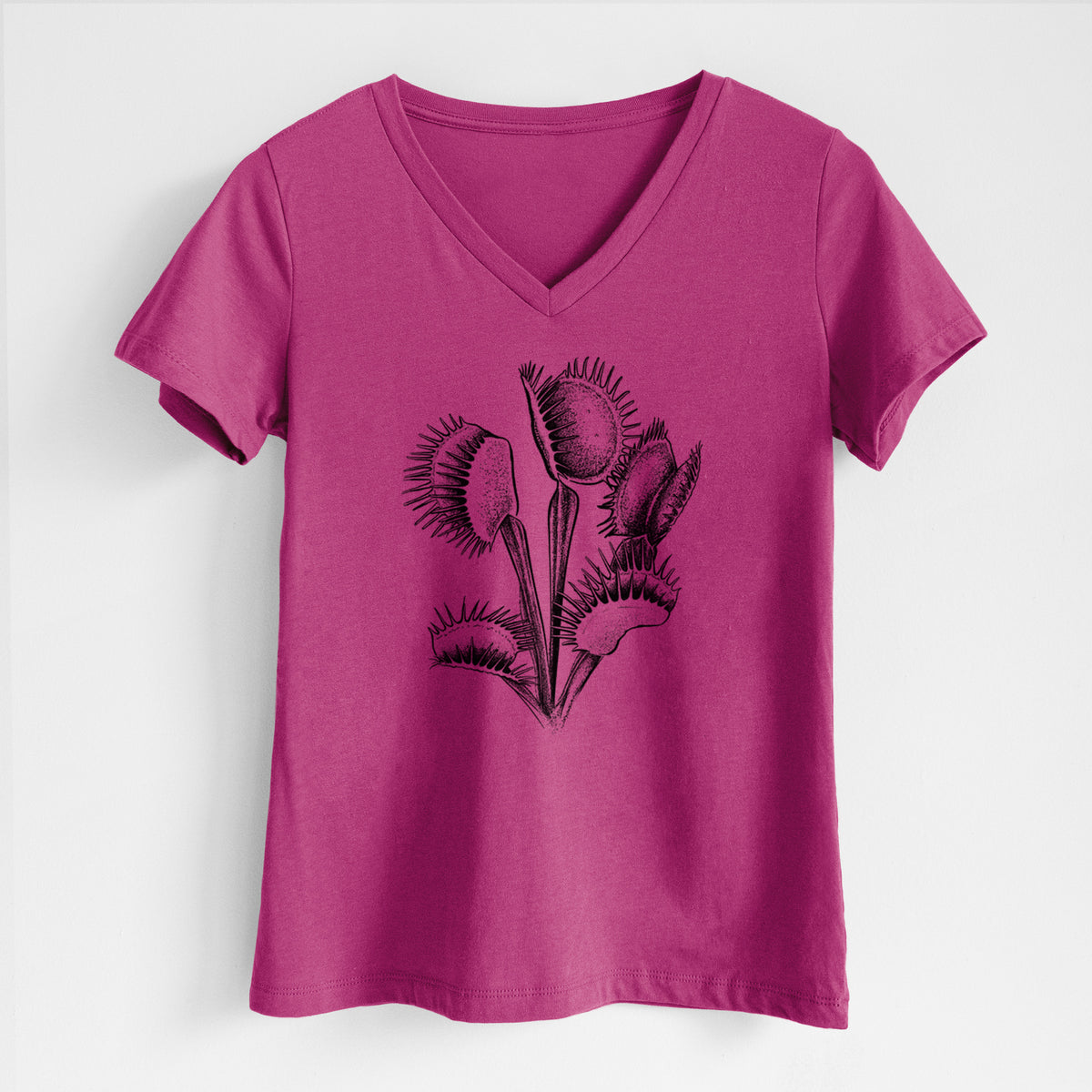 Berry pink women's relaxed fit cotton V-neck t-shirt laid flat, printed with a black ink illustration of a Venus flytrap plant with open traps.
