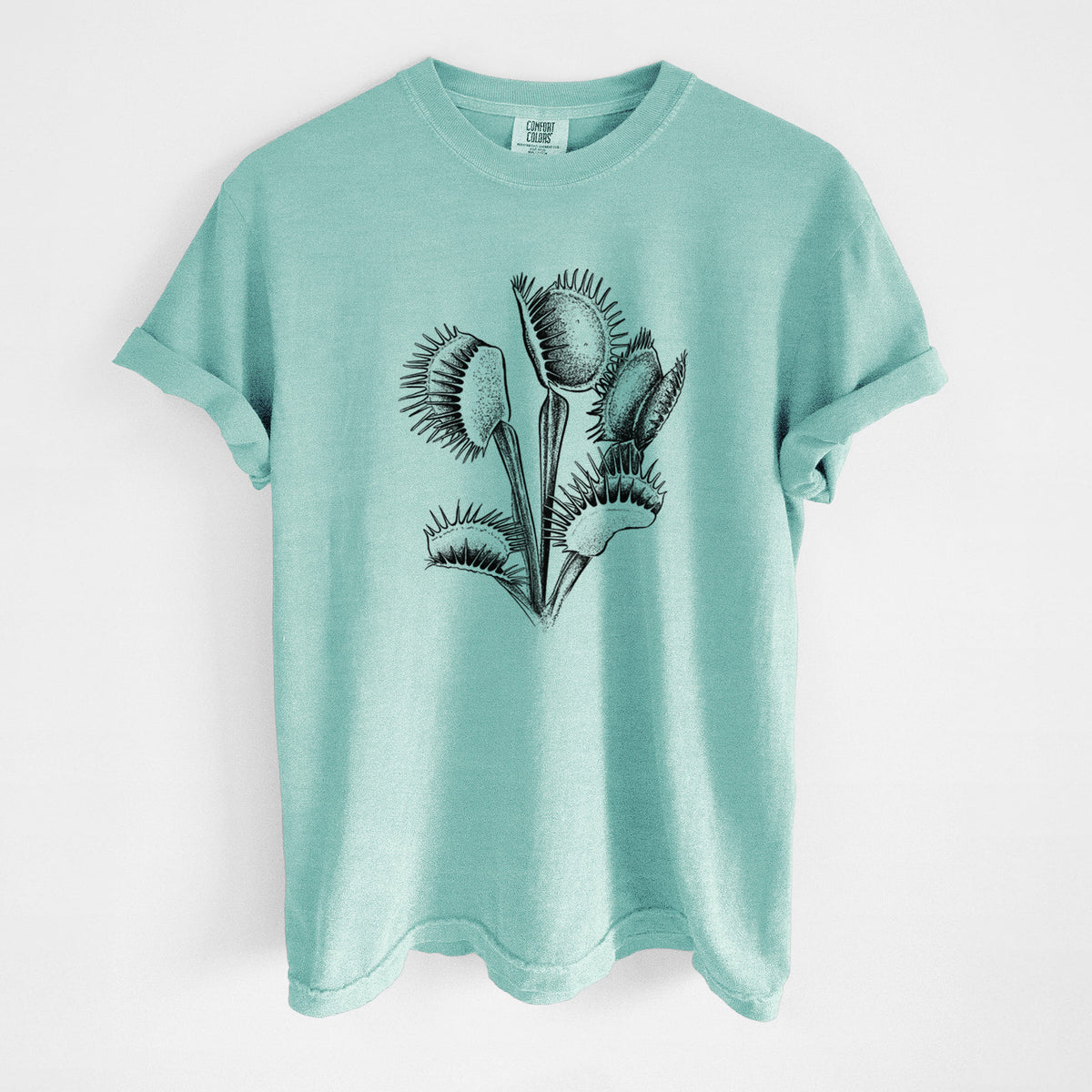Chalky mint Comfort Colors t-shirt laid flat, printed with a black ink illustration of a Venus flytrap plant with open traps.