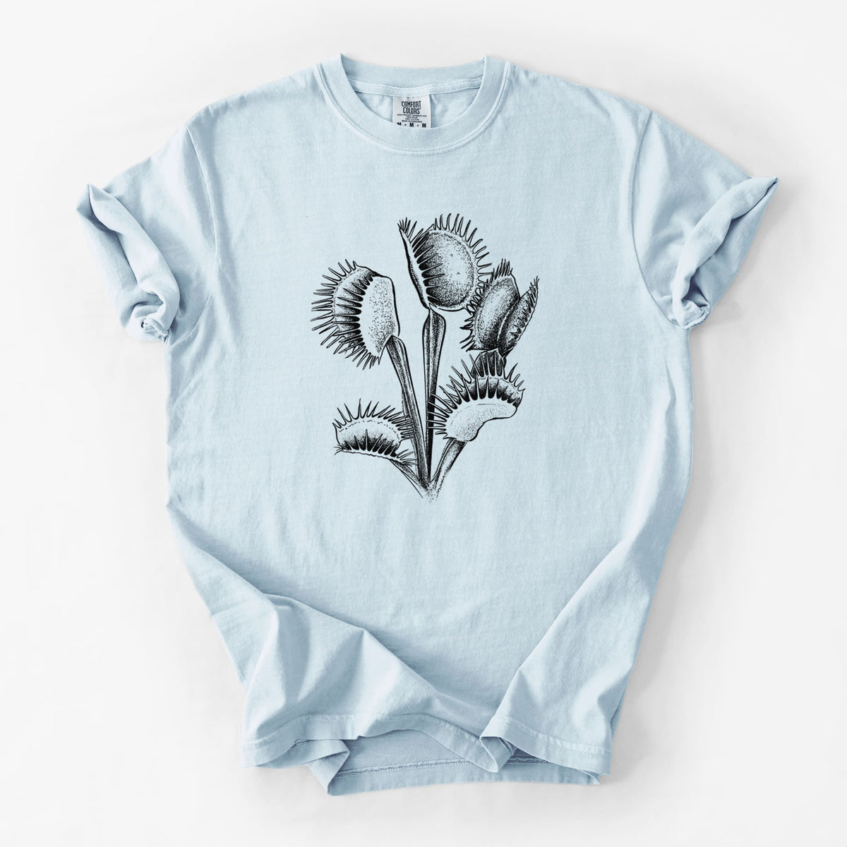 Chambray blue Comfort Colors t-shirt laid flat, printed with a black ink illustration of a Venus flytrap plant with open traps.
