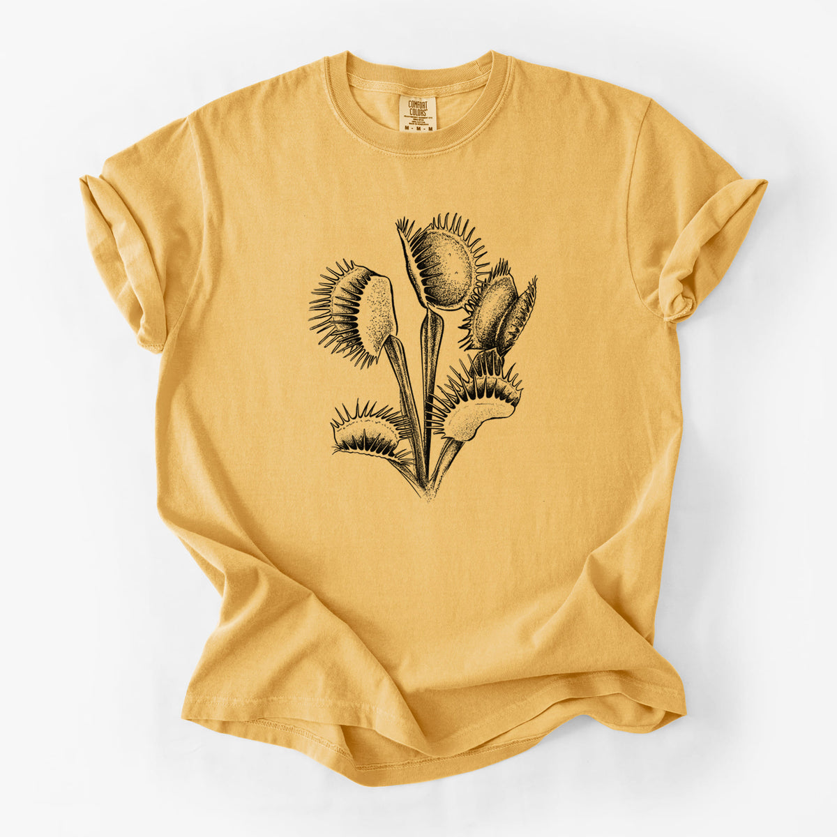 Golden wheat yellow Comfort Colors t-shirt laid flat, printed with a black ink illustration of a Venus flytrap plant with open traps.