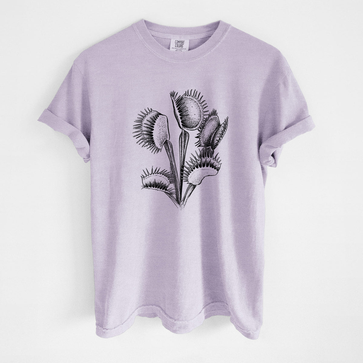 Orchid purple Comfort Colors t-shirt laid flat, printed with a black ink illustration of a Venus flytrap plant with open traps.