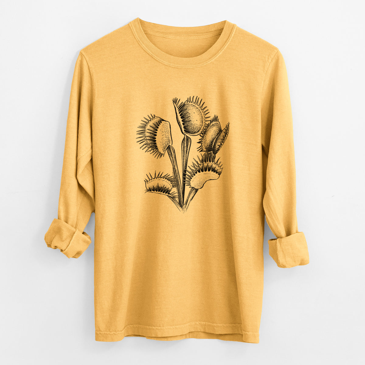 Golden wheat yellow Comfort Colors long sleeve shirt laid flat with the cuffs rolled, printed with a black ink illustration of a Venus flytrap plant with open traps.