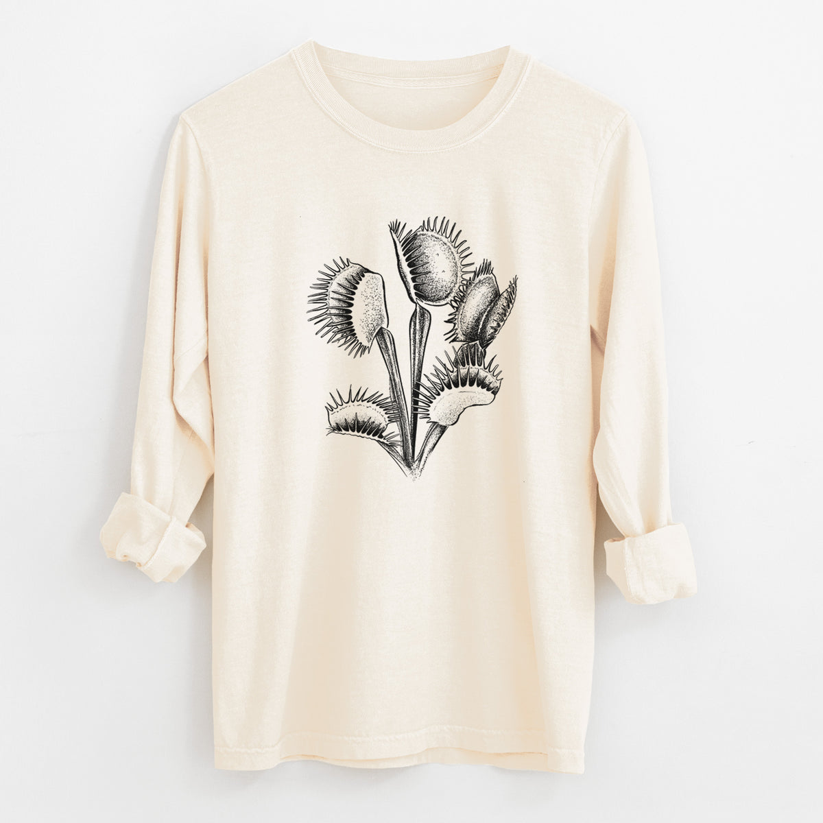 Ivory Comfort Colors long sleeve shirt laid flat with the cuffs rolled, printed with a black ink illustration of a Venus flytrap plant with open traps.
