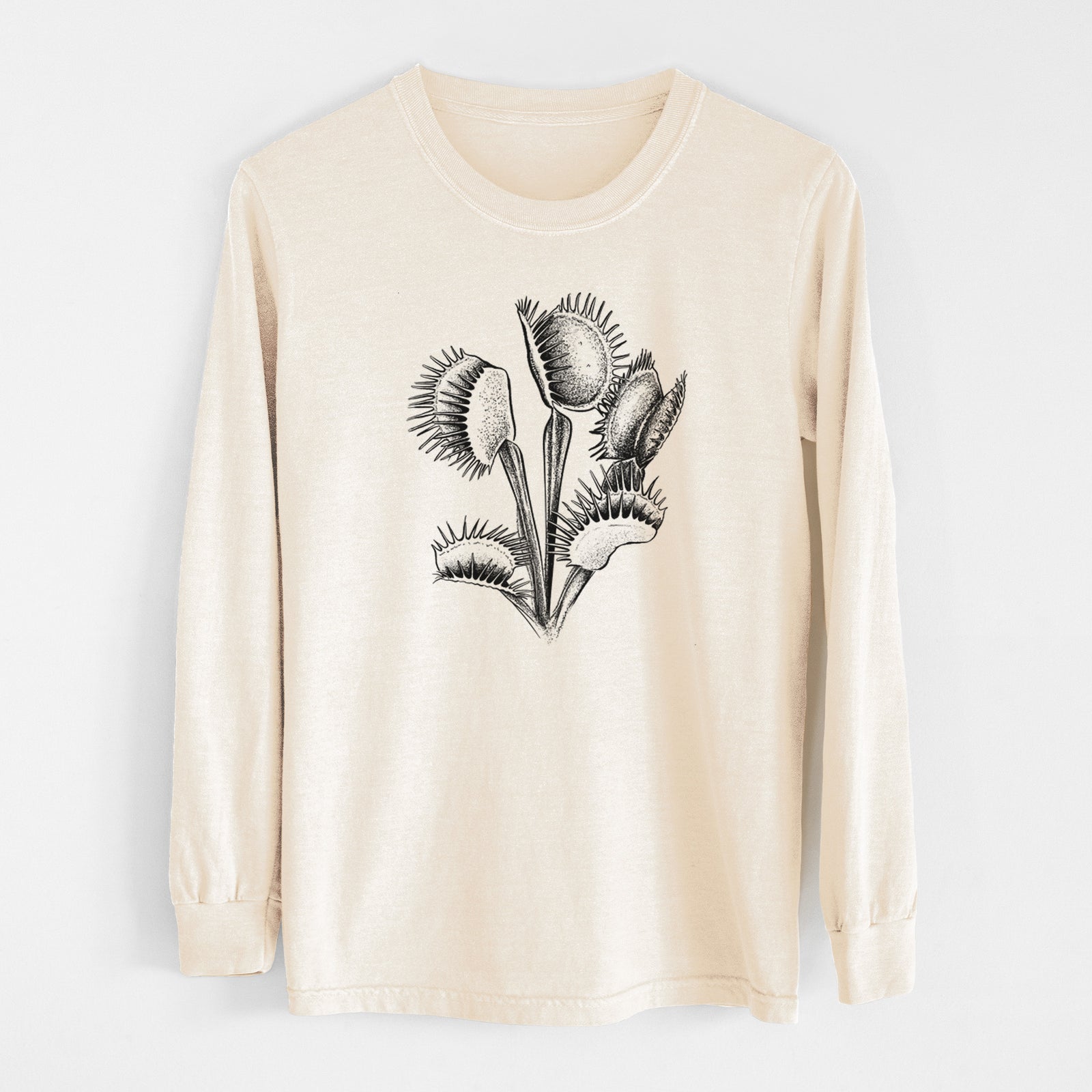 Ivory Comfort Colors long sleeve shirt laid flat, printed with a black ink illustration of a Venus flytrap plant with open traps.