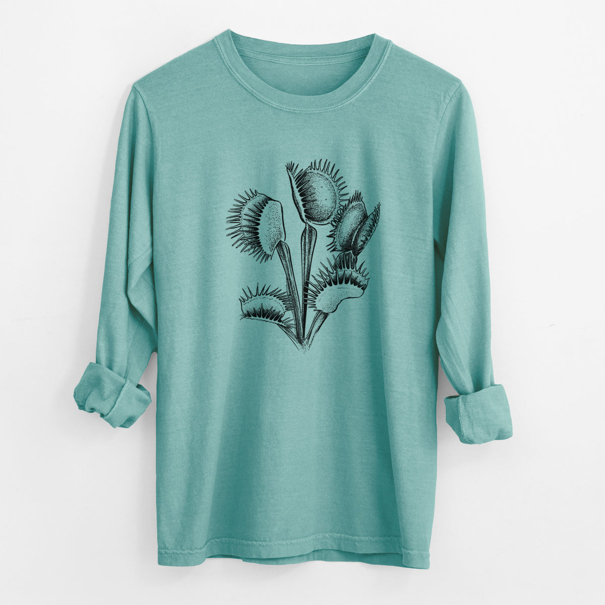 Reef green Comfort Colors long sleeve shirt laid flat with the cuffs rolled, printed with a black ink illustration of a Venus flytrap plant with open traps.