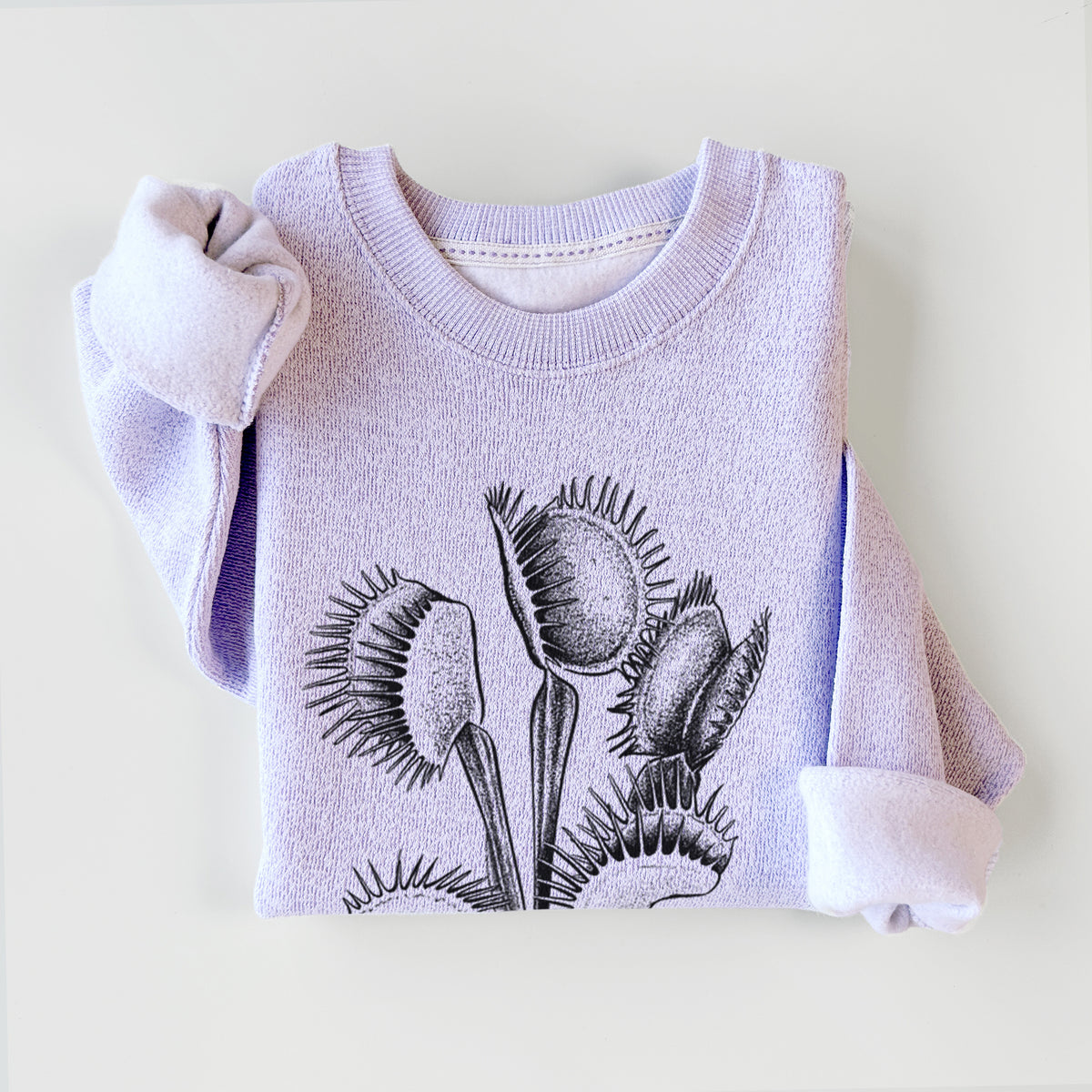 Ice purple knit sweatshirt printed with a black ink illustration of a Venus flytrap plant with open traps, styled flat.