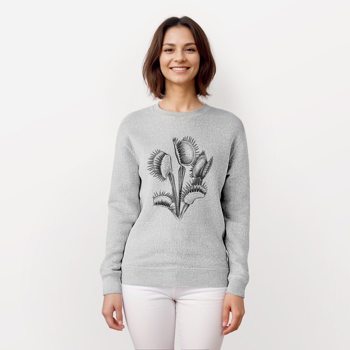 Woman wearing a knit sweatshirt printed with a black ink illustration of a Venus flytrap plant with open traps.