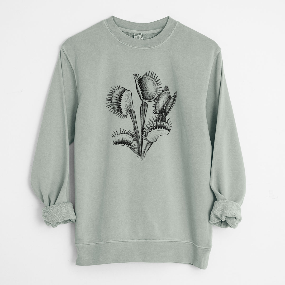 Sage green pigment dyed crewneck sweatshirt laid flat with the sleeves rolled, printed with a black ink illustration of a Venus flytrap plant with open traps.