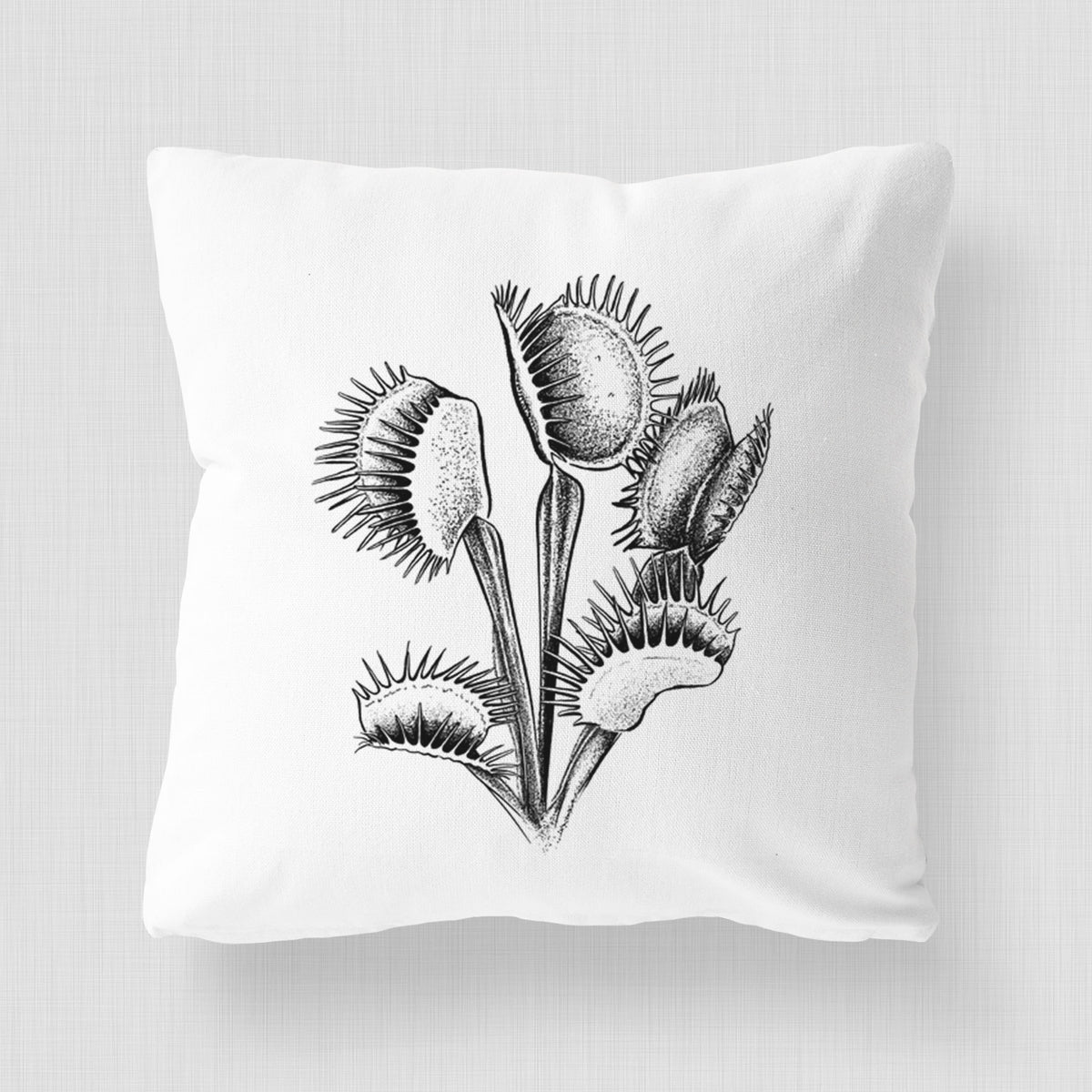 White pillow cover printed with a black ink illustration of a Venus flytrap plant with open traps.