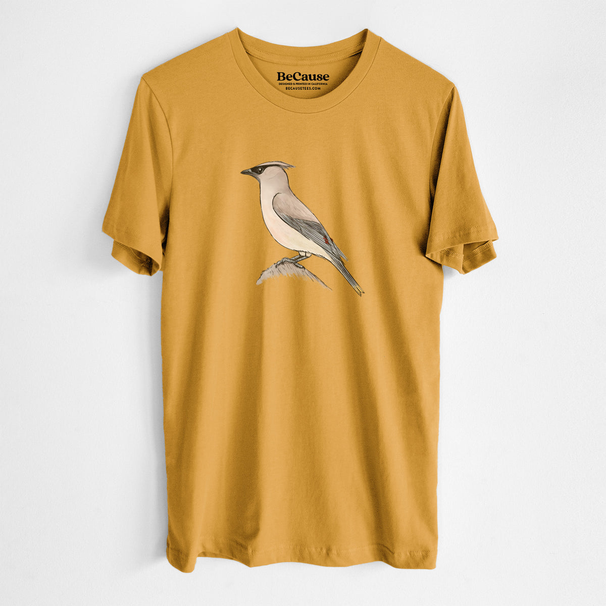 Mustard yellow lightweight cotton t-shirt laid flat, printed with a full-color illustration of a cedar waxwing perched on a branch.