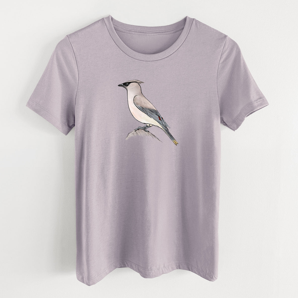 Light violet women's relaxed fit cotton t-shirt laid flat, printed with a full-color illustration of a cedar waxwing perched on a branch.