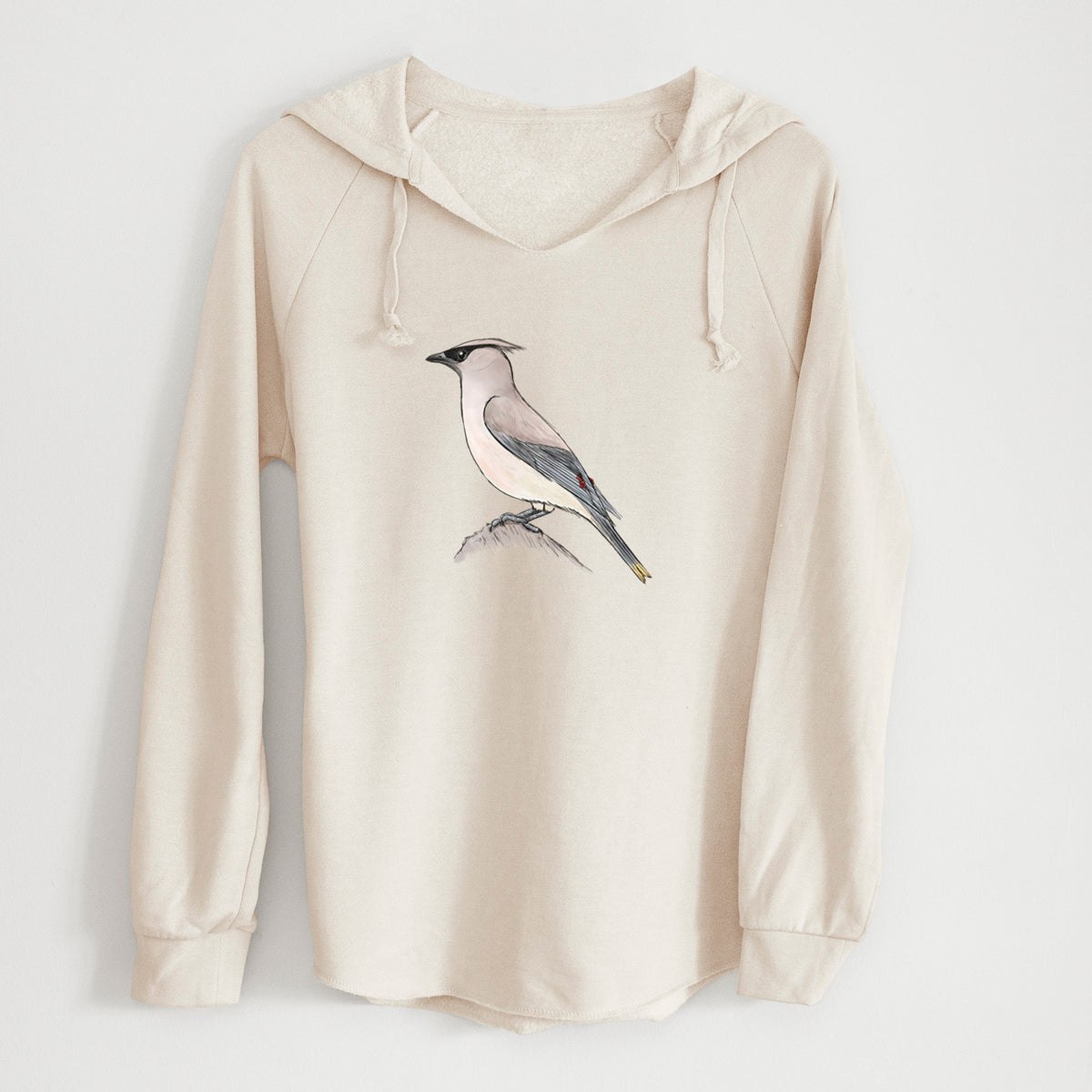 Bone cream women's Cali Wave hooded sweatshirt laid flat, printed with a full-color illustration of a cedar waxwing perched on a branch.