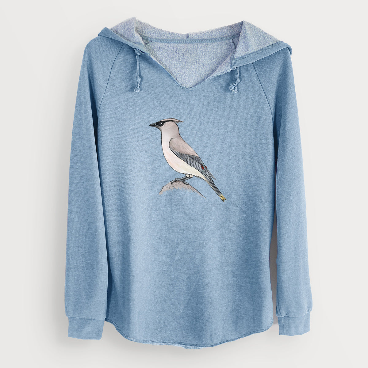 Misty blue women's Cali Wave hooded sweatshirt laid flat, printed with a full-color illustration of a cedar waxwing perched on a branch.