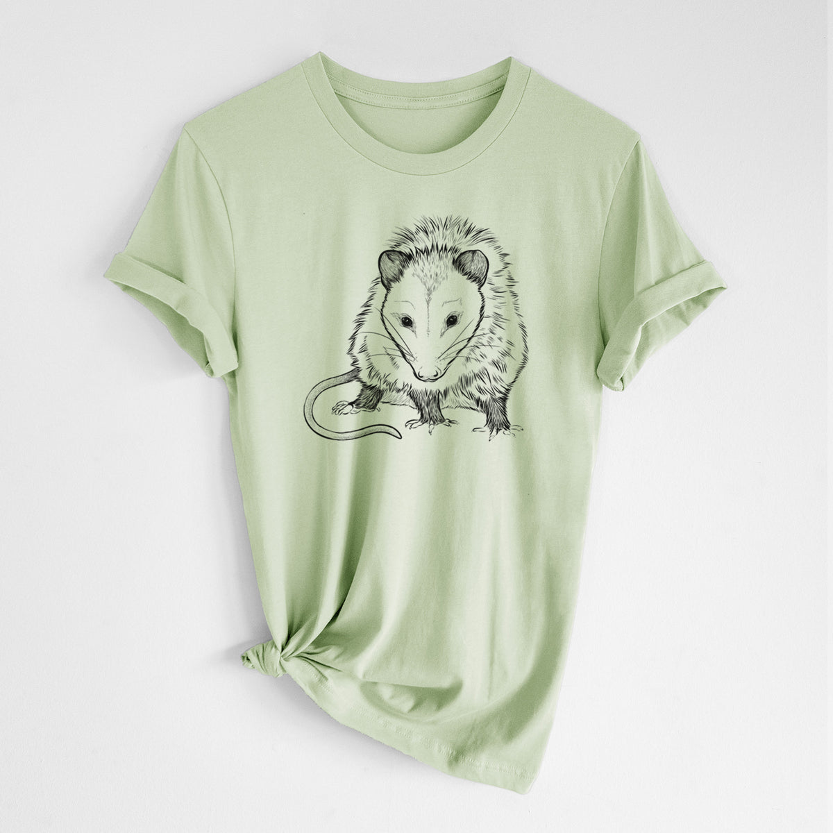 Spring green lightweight cotton t-shirt laid flat with the sleeves rolled, printed with a detailed black ink illustration of a Virginia opossum standing with its long tail curled.