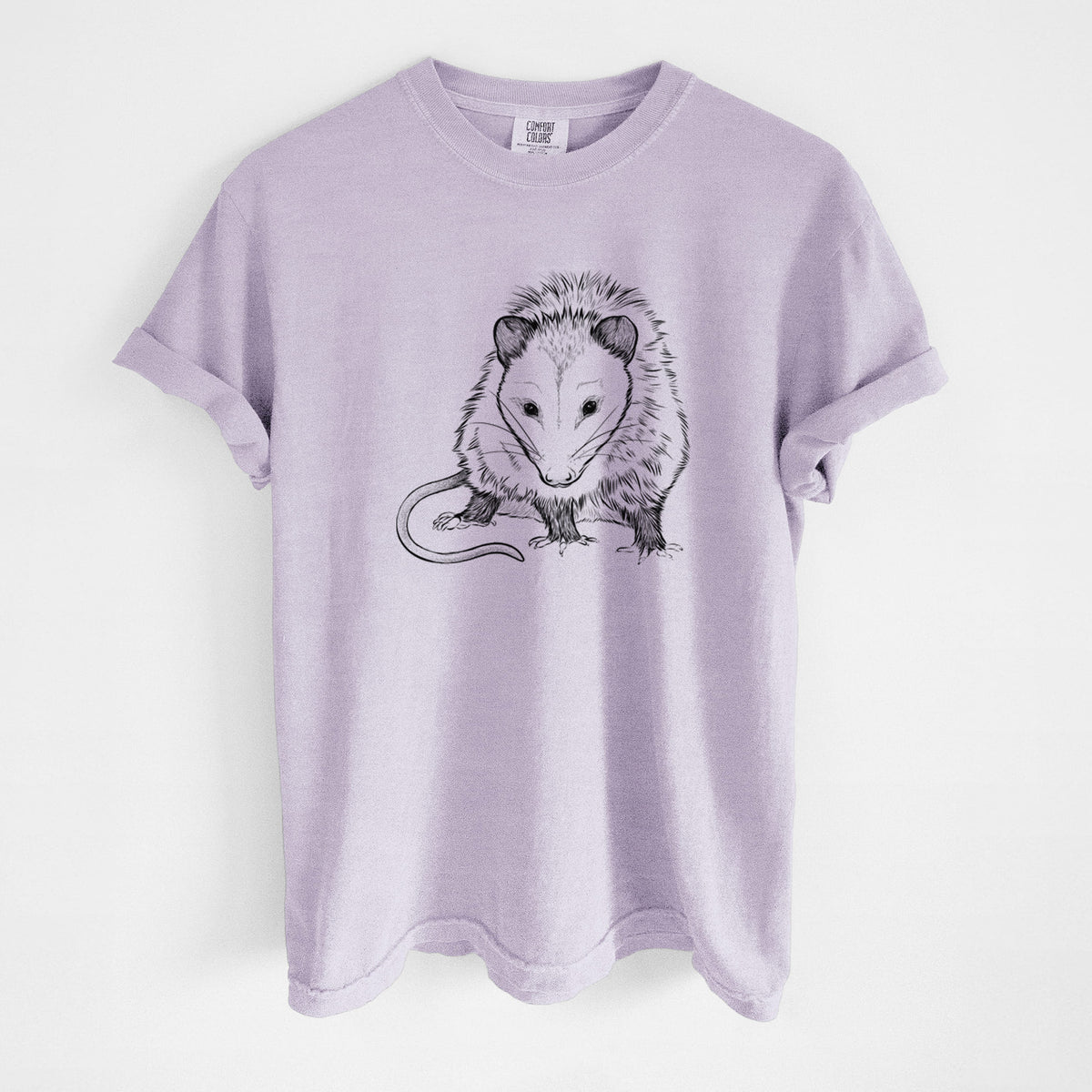 Orchid purple Comfort Colors t-shirt laid flat, printed with a detailed black ink illustration of a Virginia opossum standing with its long tail curled.