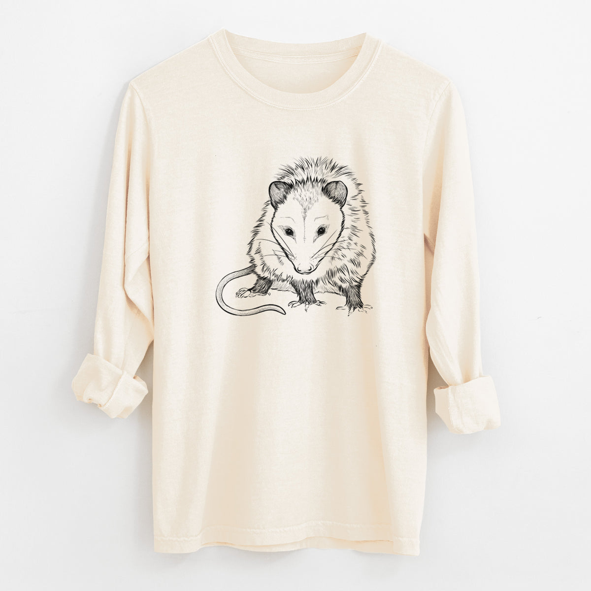 Ivory Comfort Colors long sleeve shirt laid flat with the cuffs rolled, printed with a detailed black ink illustration of a Virginia opossum standing with its long tail curled.